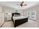 Primary bedroom suite with ceiling fan, french doors, and decorative pillows at 6409 Barkley Farm Rd, Huntersville, NC 28078