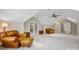 Large bonus room with plush carpeting featuring skylights and stylish leather seating arrangements at 6409 Barkley Farm Rd, Huntersville, NC 28078