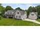 View of home and detached garage featuring a well-manicured lawn and traditional architectural design at 6409 Barkley Farm Rd, Huntersville, NC 28078