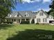 Charming home featuring a covered front porch, lush lawn, and mature landscaping at 6409 Barkley Farm Rd, Huntersville, NC 28078