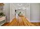 Inviting foyer with hardwood floors leading to a spacious living room featuring large windows and a fireplace at 6409 Barkley Farm Rd, Huntersville, NC 28078