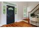Elegant foyer showcasing hardwood floors, a staircase, and a black front door with decorative glass at 6409 Barkley Farm Rd, Huntersville, NC 28078