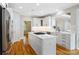 Bright kitchen featuring white cabinets, stainless steel appliances, and a large island with counter seating at 6409 Barkley Farm Rd, Huntersville, NC 28078