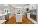Spacious kitchen with white cabinets, stainless steel appliances, and a central island with a gas cooktop at 6409 Barkley Farm Rd, Huntersville, NC 28078