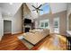 Bright living room with hardwood floors, a stone fireplace, and a vaulted ceiling with large windows at 6409 Barkley Farm Rd, Huntersville, NC 28078