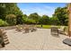 Stone patio featuring comfortable seating and a fire pit with views of the backyard at 6409 Barkley Farm Rd, Huntersville, NC 28078