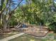 Neighborhood playground featuring slides, swings, and picnic tables nestled in a wooded area at 6409 Barkley Farm Rd, Huntersville, NC 28078