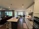 Well-lit kitchen featuring a large center island with sleek countertops and stainless steel appliances at 7057 Kingfisher Way, Belmont, NC 28012