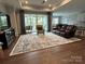 Spacious living room features hardwood floors, a large window, and recessed lighting at 7057 Kingfisher Way, Belmont, NC 28012