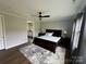 Serene main bedroom featuring a ceiling fan and a view into ensuite bathroom at 7057 Kingfisher Way, Belmont, NC 28012