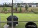 View from screened porch showing manicured backyard and neighborhood landscape at 7057 Kingfisher Way, Belmont, NC 28012