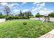 Expansive backyard featuring a fire pit, play set, and well-maintained lawn at 8829 Keller Ct, Huntersville, NC 28078