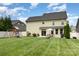 Picturesque backyard with a playset, patio, seating, and lush green grass at 8829 Keller Ct, Huntersville, NC 28078