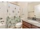 Bathroom featuring a granite countertop vanity, a floral shower curtain, and tiled flooring at 8829 Keller Ct, Huntersville, NC 28078