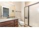 Updated bathroom with granite countertops, modern fixtures, and walk-in shower at 8829 Keller Ct, Huntersville, NC 28078