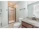 Bathroom with granite countertop vanity and walk-in shower with a tiled surround and glass door at 8829 Keller Ct, Huntersville, NC 28078