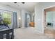 Spacious bedroom with natural light from multiple windows, and a wooden dresser, ideal for relaxation at 8829 Keller Ct, Huntersville, NC 28078
