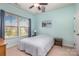Comfortable bedroom with blue walls and a large window, offering a peaceful ambiance and great views at 8829 Keller Ct, Huntersville, NC 28078