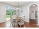 Charming breakfast nook with wood floors, a round table, and a sliding glass door to the backyard at 8829 Keller Ct, Huntersville, NC 28078