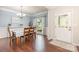 Formal dining area with hardwood floors, a chandelier, and a large window offering natural light at 8829 Keller Ct, Huntersville, NC 28078