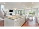 Spacious kitchen island with granite countertops, a stainless steel dishwasher, and a view of the living room at 8829 Keller Ct, Huntersville, NC 28078