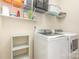Well-organized laundry room with shelving and modern washer and dryer at 8829 Keller Ct, Huntersville, NC 28078