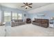 Spacious living room with neutral color palette, ceiling fan, and comfortable seating at 8829 Keller Ct, Huntersville, NC 28078