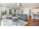 Inviting living room featuring hardwood floors, a comfortable sectional sofa, and bright natural light at 8829 Keller Ct, Huntersville, NC 28078