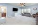 Comfortable living room features a wall-mounted TV, plush sofa, and large windows at 8829 Keller Ct, Huntersville, NC 28078