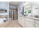 Spacious main bathroom featuring double sinks, a soaking tub with fireplace, and a separate tiled shower at 8829 Keller Ct, Huntersville, NC 28078