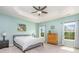 Spacious main bedroom with tray ceiling, a ceiling fan, and large windows offering bright, natural light at 8829 Keller Ct, Huntersville, NC 28078