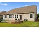 Image showcases a backyard with a patio, swing set, and fire pit, ideal for outdoor activities at 8830 Artesa Mill Ln, Charlotte, NC 28214