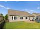 View of a well-maintained backyard, complete with a patio, swing set, and privacy fence at 8830 Artesa Mill Ln, Charlotte, NC 28214