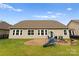Image of a fenced backyard that features a patio area, swing set, and fire pit for outdoor enjoyment at 8830 Artesa Mill Ln, Charlotte, NC 28214