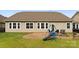 Shows a spacious backyard featuring a patio, swing set, and outdoor seating, perfect for relaxation at 8830 Artesa Mill Ln, Charlotte, NC 28214