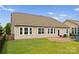 A backyard with a patio, swing set, and manicured lawn, perfect for outdoor enjoyment and entertaining at 8830 Artesa Mill Ln, Charlotte, NC 28214