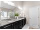 Bright bathroom featuring granite double vanity, white cabinets, and glass shower at 8830 Artesa Mill Ln, Charlotte, NC 28214