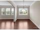Open-concept dining area with hardwood floors, natural light, and elegant chandelier at 8830 Artesa Mill Ln, Charlotte, NC 28214