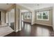 Open dining area featuring hardwood floors, arched entries, and plenty of natural light at 8830 Artesa Mill Ln, Charlotte, NC 28214