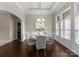 Bright dining room with hardwood floors, elegant chandelier, and large windows at 8830 Artesa Mill Ln, Charlotte, NC 28214