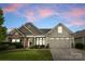 Charming single Gathering home with a two car garage and manicured front yard at 8830 Artesa Mill Ln, Charlotte, NC 28214
