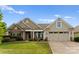 Charming single-Gathering home with stone accents, neutral siding, manicured lawn, and a two-car garage at 8830 Artesa Mill Ln, Charlotte, NC 28214