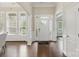 Bright foyer showcasing hardwood floors, large windows, and a welcoming entrance with an elegant welcome mat at 8830 Artesa Mill Ln, Charlotte, NC 28214