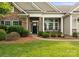 Inviting front entrance with stone accents and lush landscaping that adds to the curb appeal at 8830 Artesa Mill Ln, Charlotte, NC 28214