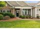A welcoming front entrance featuring stone accents, lush landscaping, and a paved walkway at 8830 Artesa Mill Ln, Charlotte, NC 28214