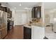 Modern kitchen with stainless steel appliances, granite countertops, and dark wood cabinets at 8830 Artesa Mill Ln, Charlotte, NC 28214