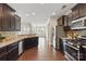 Well-appointed kitchen with granite countertops, stainless steel appliances, and dark cabinetry at 8830 Artesa Mill Ln, Charlotte, NC 28214