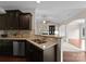 Beautiful kitchen with dark wood cabinets, granite countertops and stainless steel dishwasher at 8830 Artesa Mill Ln, Charlotte, NC 28214