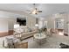 Open-concept living room with hardwood floors, kitchen view, and stylish furniture at 8830 Artesa Mill Ln, Charlotte, NC 28214