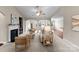 Spacious living room with a fireplace, neutral carpet, and open access to other rooms at 8830 Artesa Mill Ln, Charlotte, NC 28214